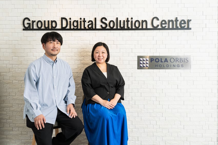 Pola Orbis Holdings security team leaders Iihara and Yamamoto pose at the Group Digital Solution Center office entrance.